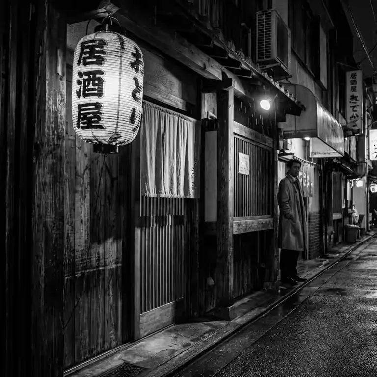 Izakaya entrance with paper lantern and rain